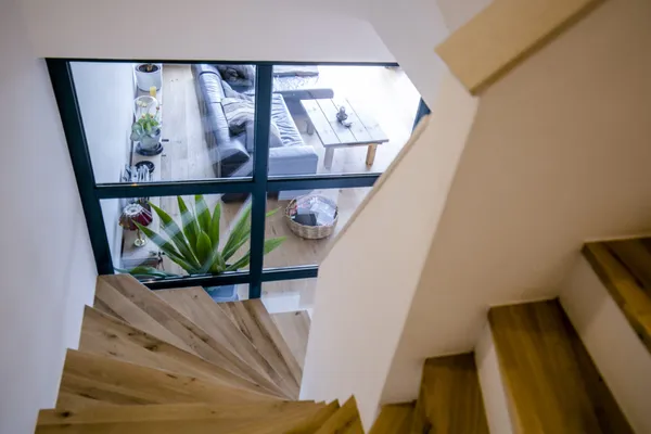 Holztreppe vor einer großen Fensterfront